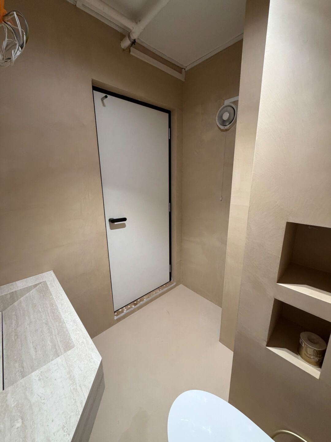 Microcement bathroom walls and floor, with built-in wall niches