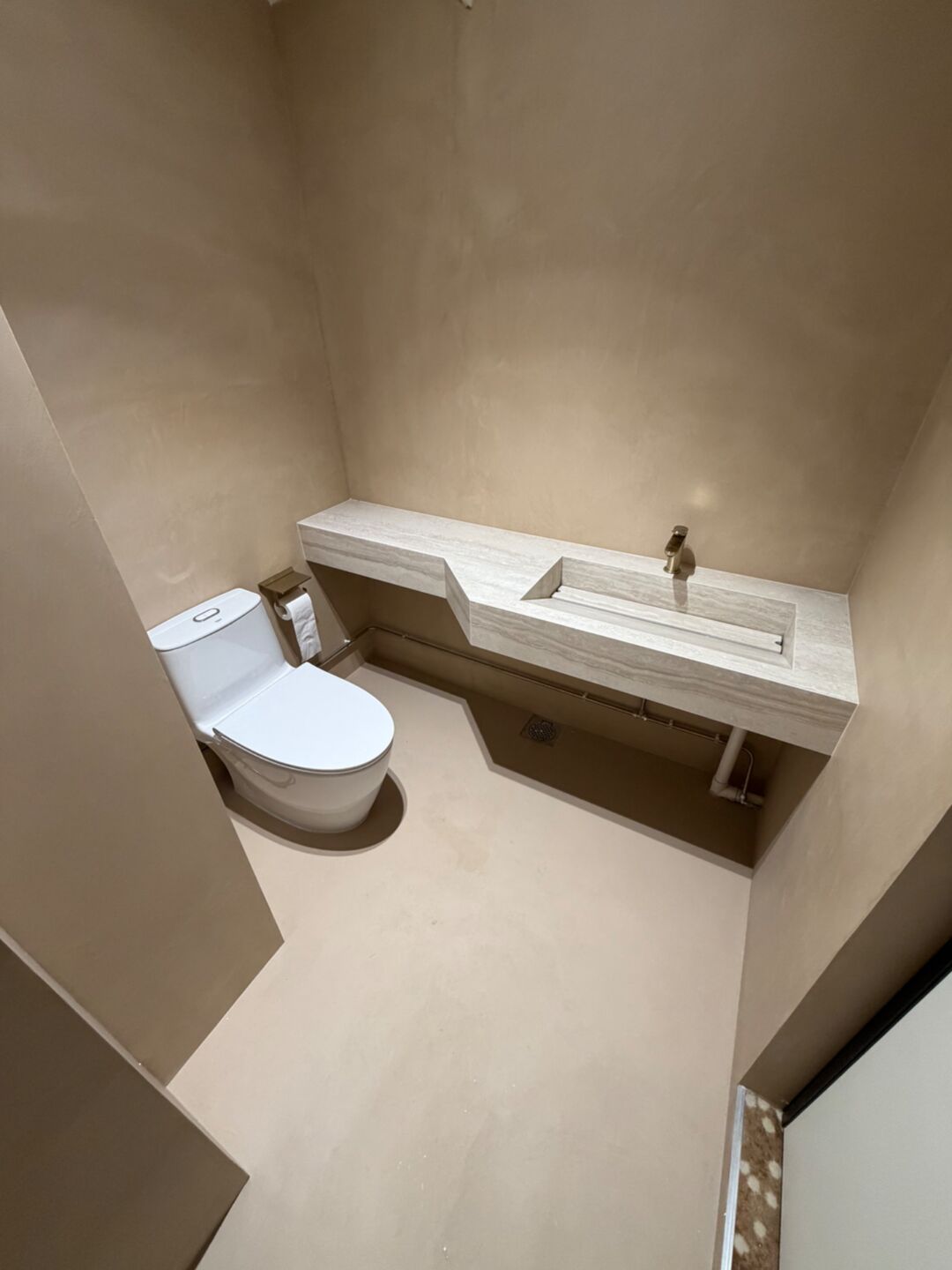 Microcement vanity with an integrated basin, walls and floor in one finish