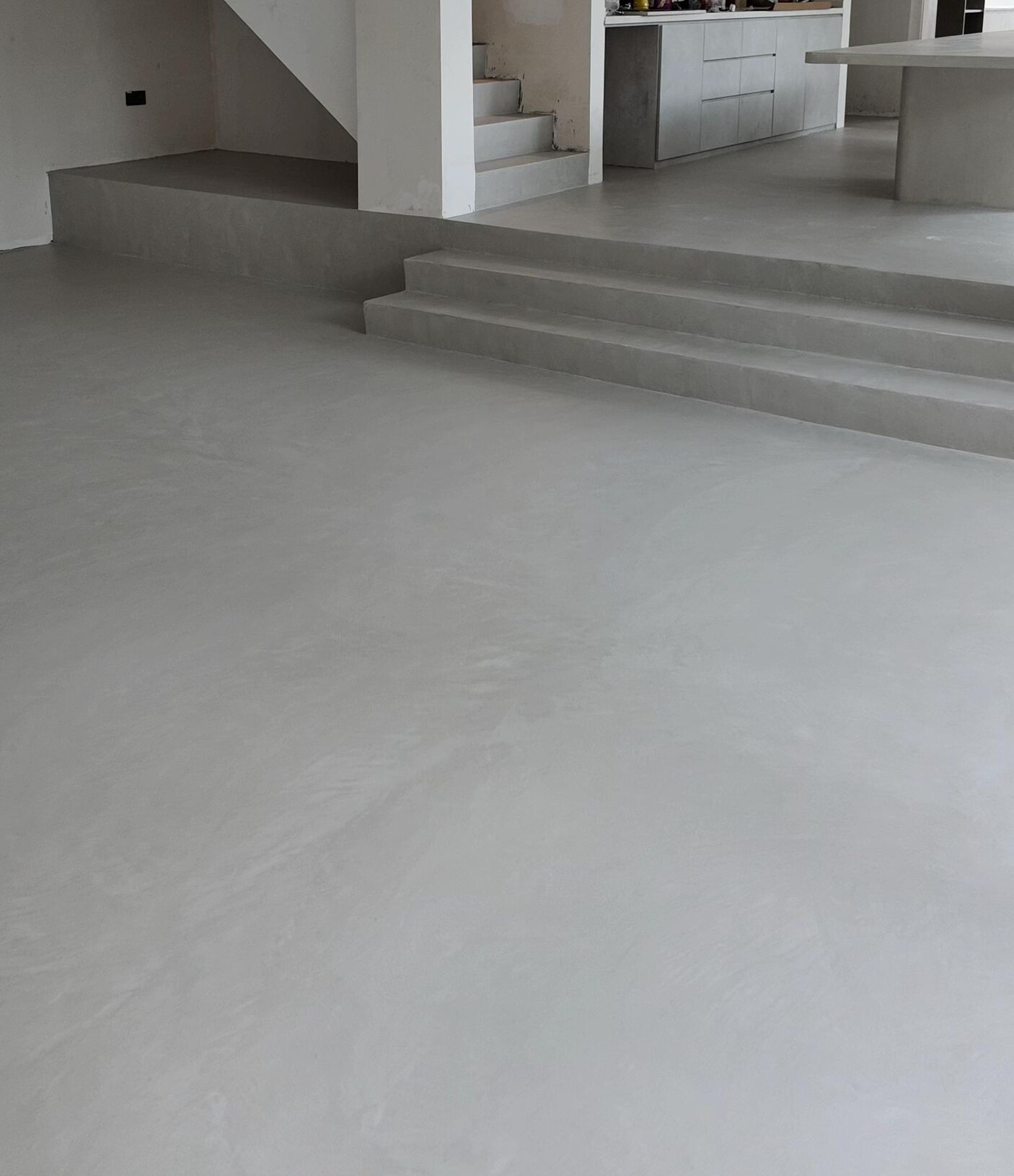 Landed home with a seamless microcement floor and steps