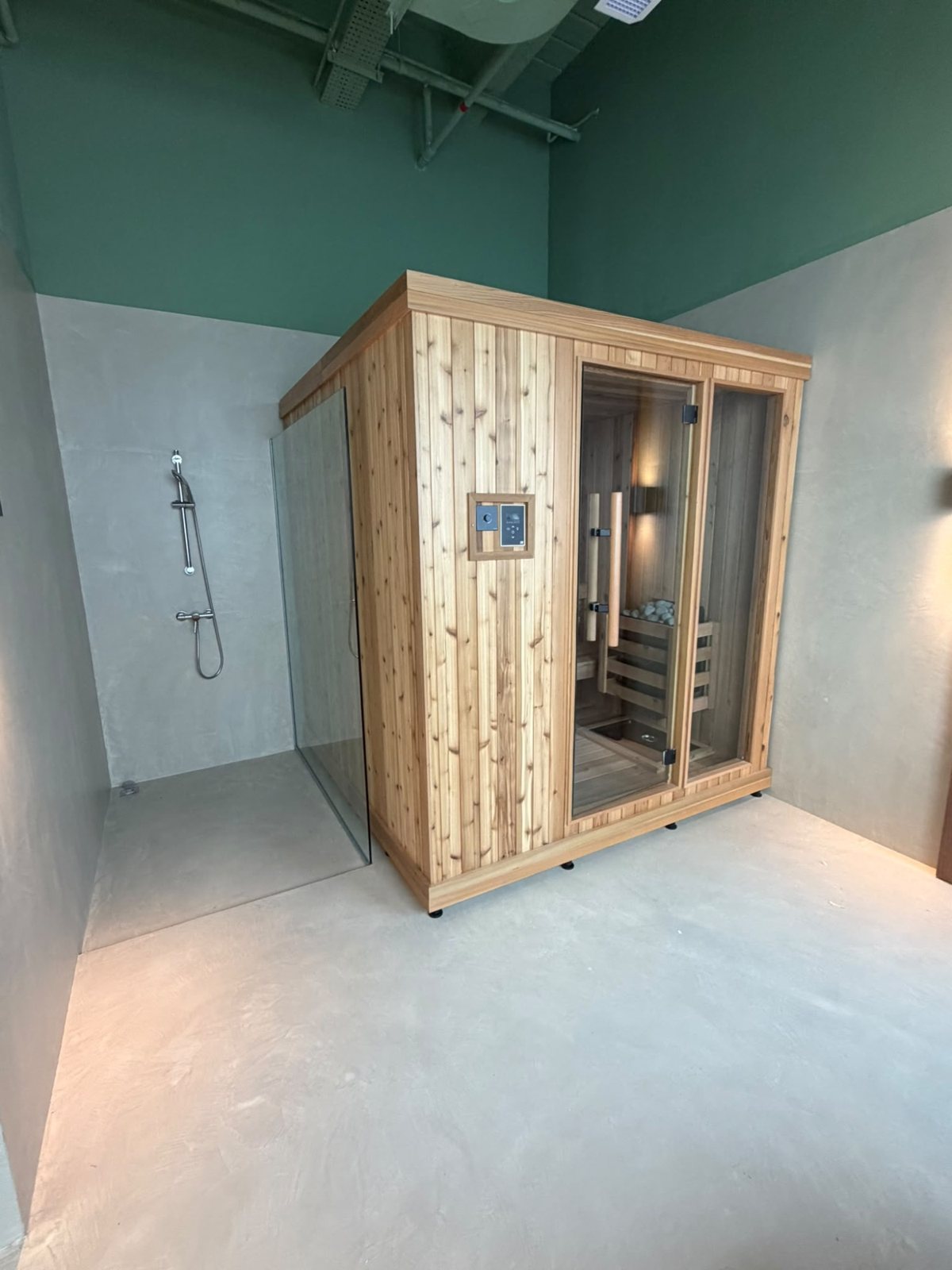 Microcement walls and floor around a sauna cabin
