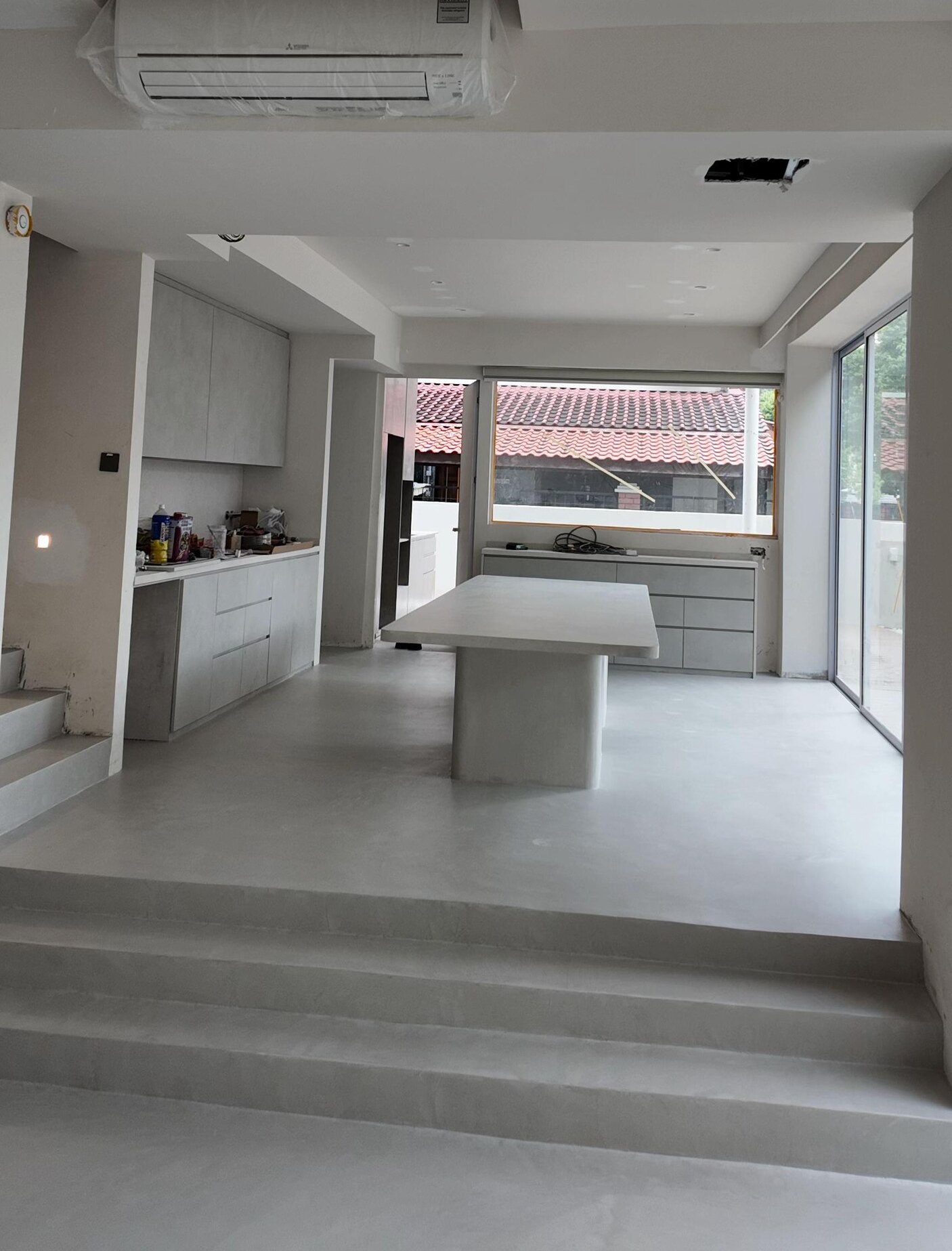 Kitchen and dining on one continuous microcement surface
